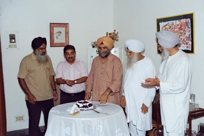 What's a birthday without cutting a cake! From left: Jaspal Chattha, Rajiv Arora, the birthday boy and his father, and Prof Gurinder Mann.