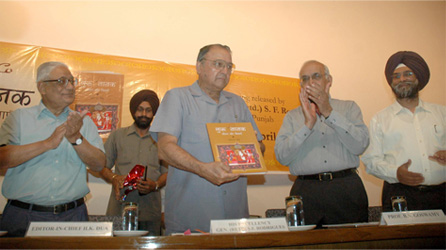 The Punjab Governor and Administrator, Union Territory, Chandigarh, Gen. (Retd.) S. F. Rodrigues, releasing the book GURU NANAK: HIS LIFE & TEACHINGS (Hindi) by Roopinder Singh. Others on the dais are H. K. Dua, Editor-in-Chief of the Tribune (extreme left), Prof B. N. Goswamy (third from left), and the author (right).